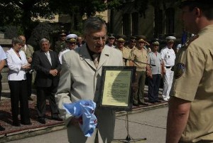 Dr. Simeon Kralikov (l), chapter president, presents an award to Capt. Valery Todorov in July.